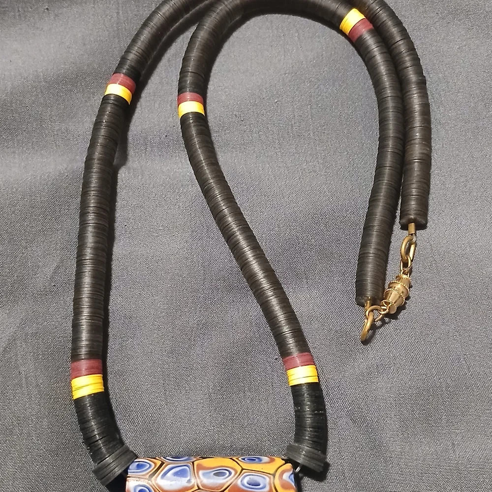 Black Disc Bead Necklace with Yellow and Red Accent Rings and Patterned Pendant